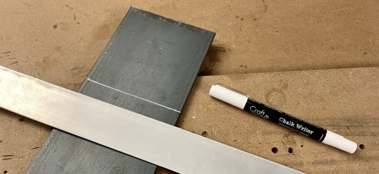 Cut the heavy steel plate to fit neatly under the scale bed